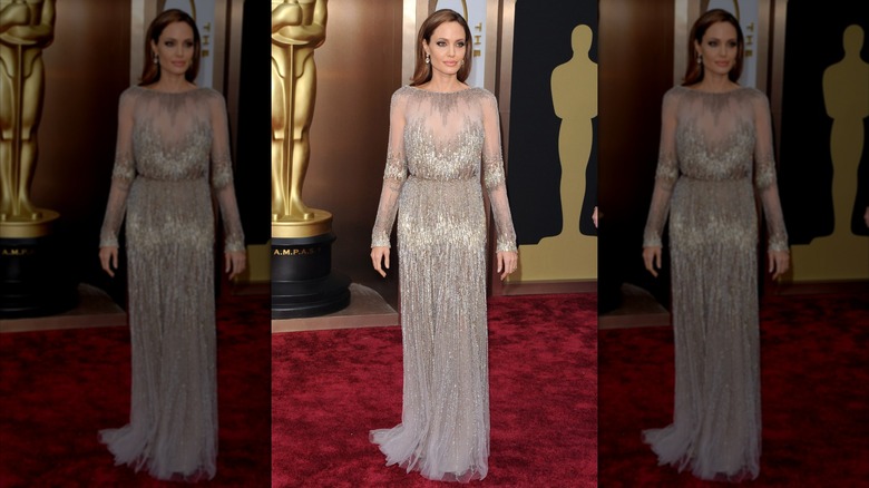 Angelina Jolie wearing a modest silver dress at the 2014 Oscars.