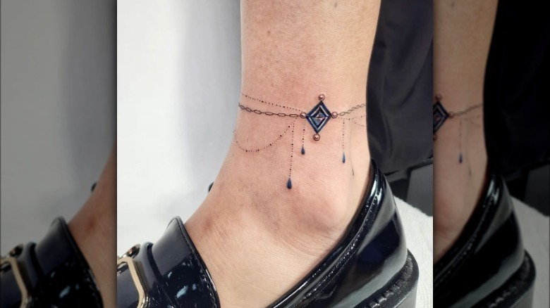 Blue and gray anklet tattoo