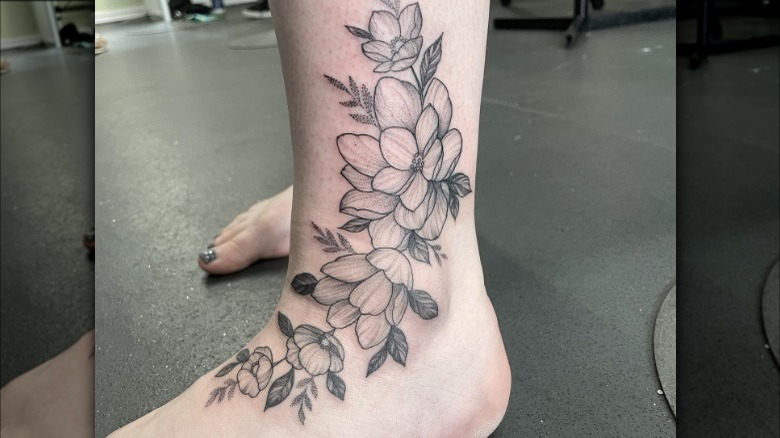 Large floral tattoo on ankle