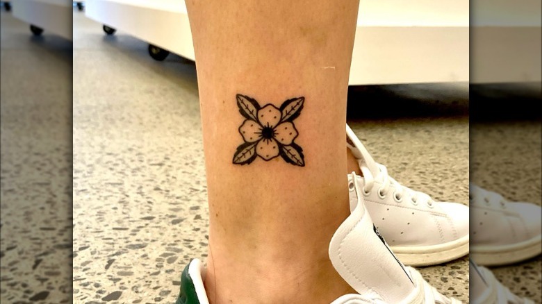 Hand-poked flower tattoo on ankle