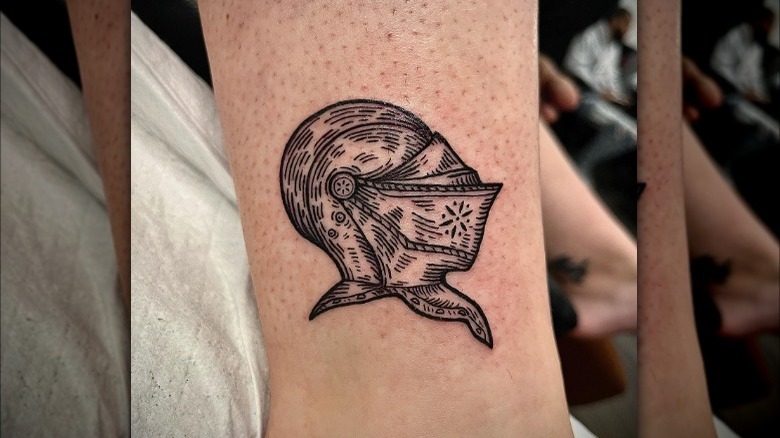 Linework medieval knight helmet tattoo