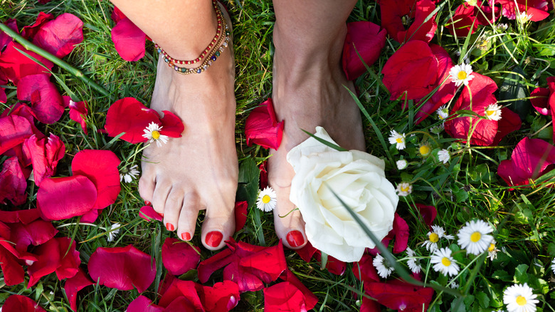 feet flowers and beaded anklets