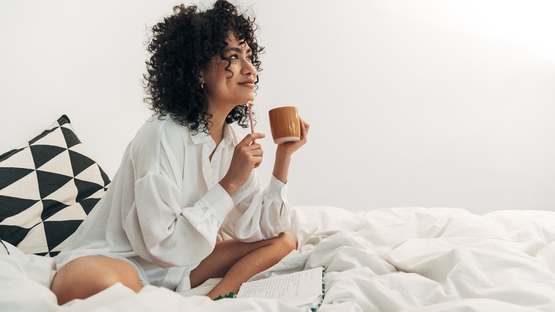 Woman journaling in bed