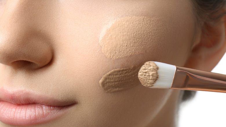 Girl applying concealer