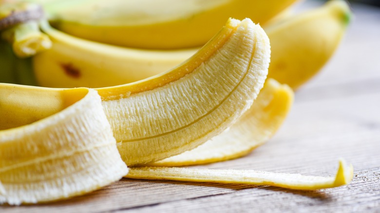 Banana and hand holding syringe 