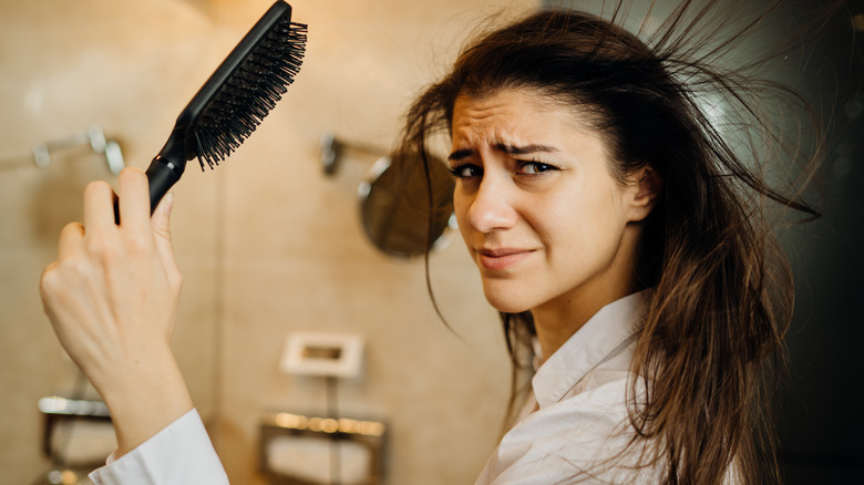 Woman giving herself a blowout