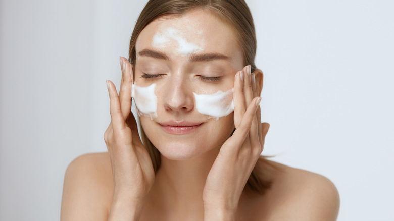 woman cleansing face