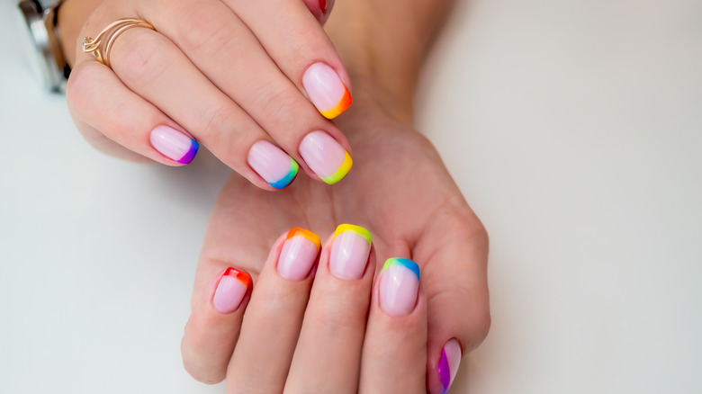 woman with colorful french manicure