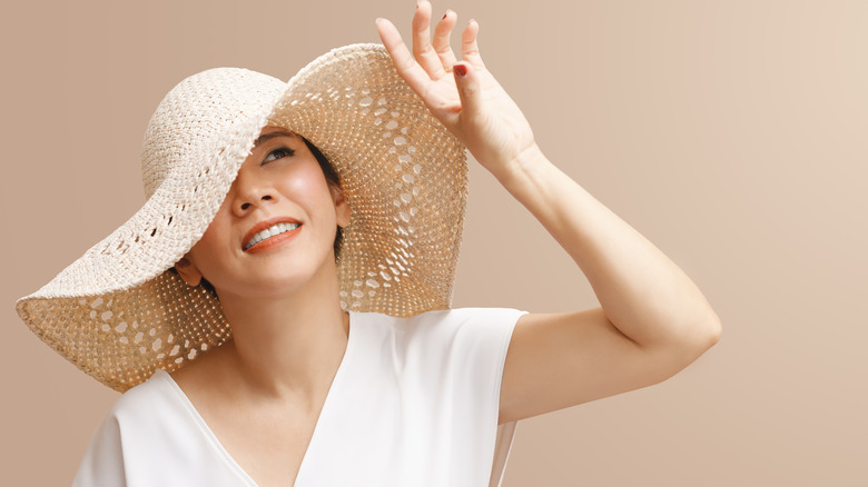 Woman in hat avoids sun