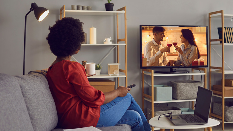 Woman watching movie alone in living room