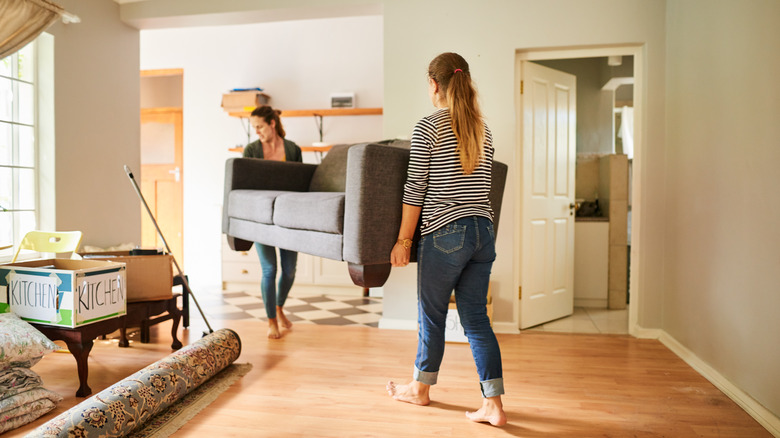 Roommates moving couch together