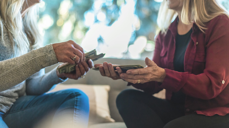 Friends exchanging cash