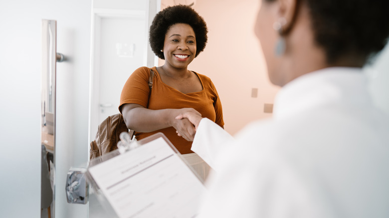 Woman shaking hands with doctor