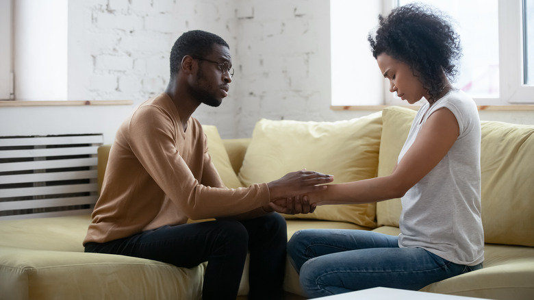 upset couple holding hands