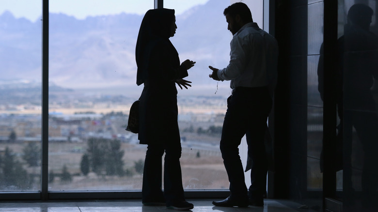 Couple argues by window