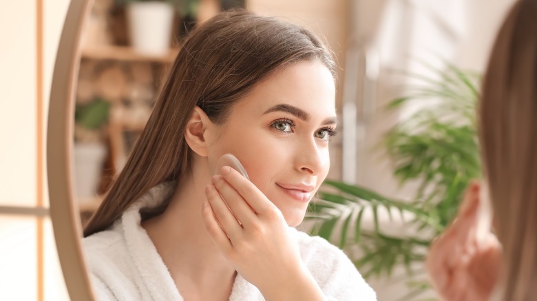 woman applying makeup with beauty sponge