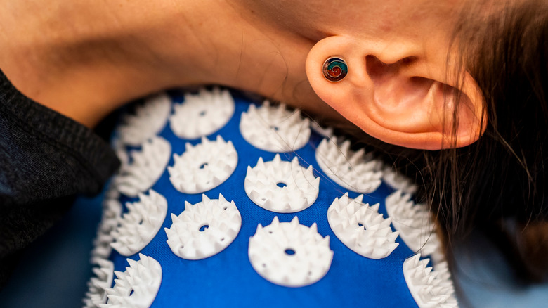 female neck on acupressure mat