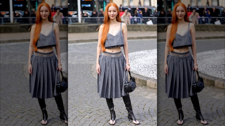 Person in gray skirt and black thong boots