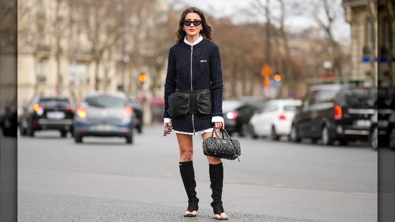 Person in sweater dress and thong boots