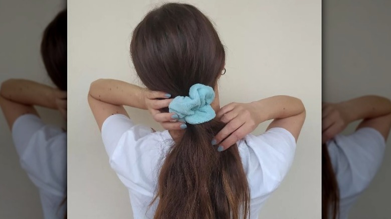 women with towel scrunchie ponytail