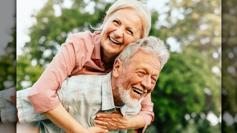 Senior couple laughing outside