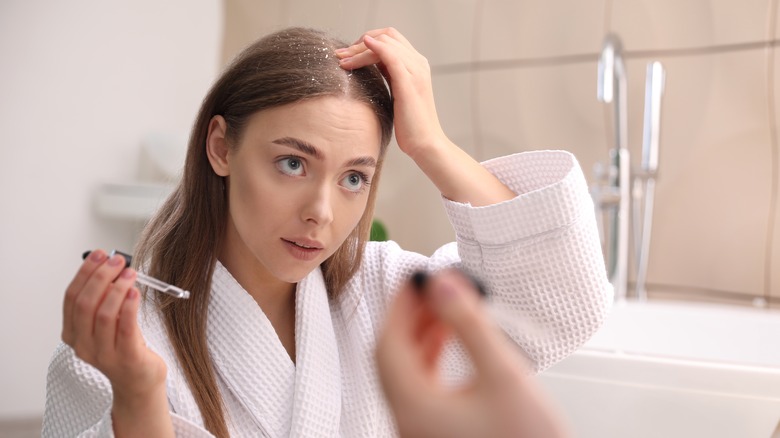 woman applying product to scalp