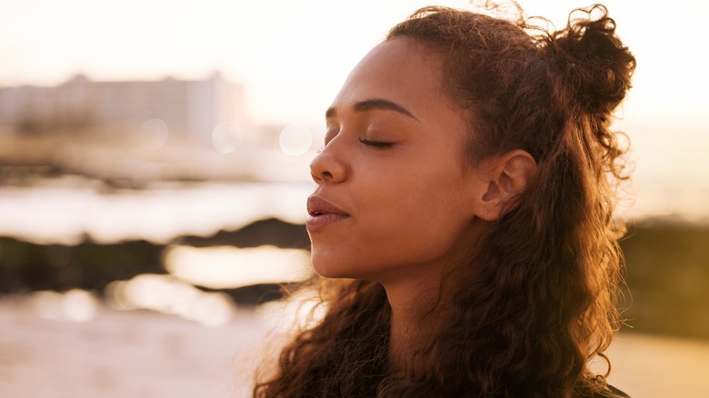 Woman breathing with eyes closed