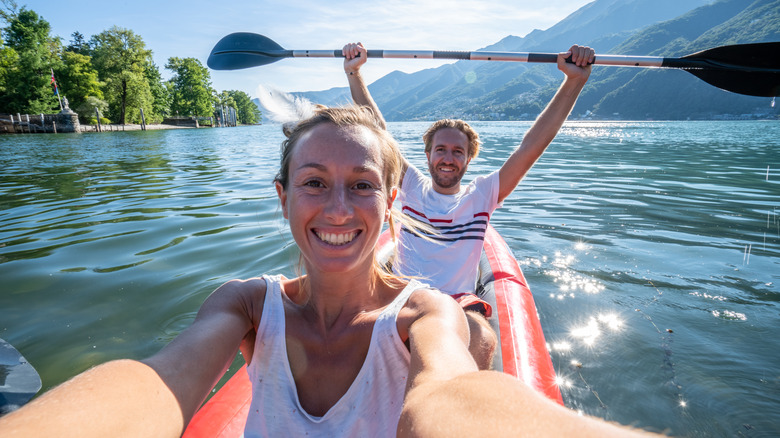 Couple kayaking in lake