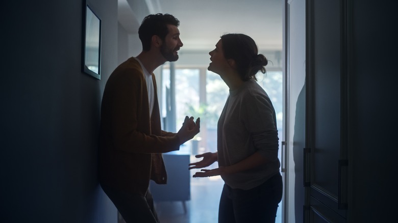 Couple fighting in the hallway