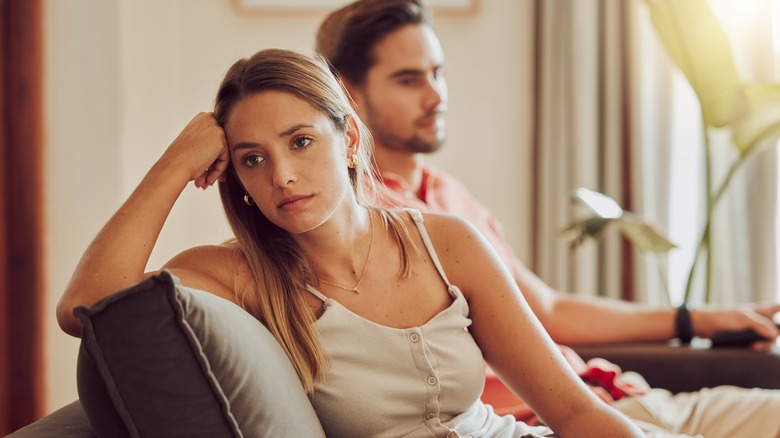 Sad woman sitting with partner