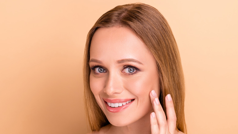 Woman applying liquid highlighter