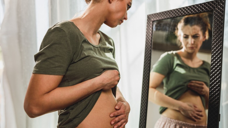 frowning woman bloated