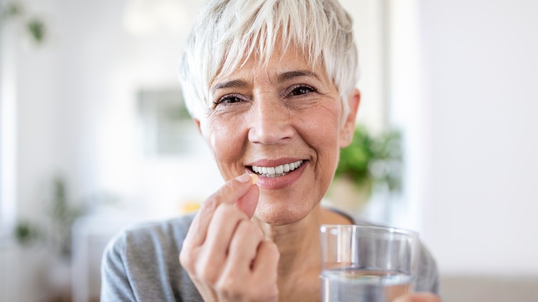 woman medicine pill water