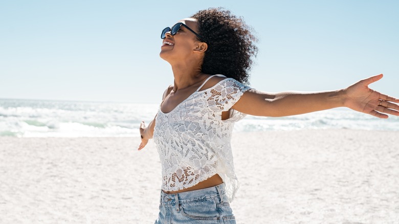 woman outdoors hands in air