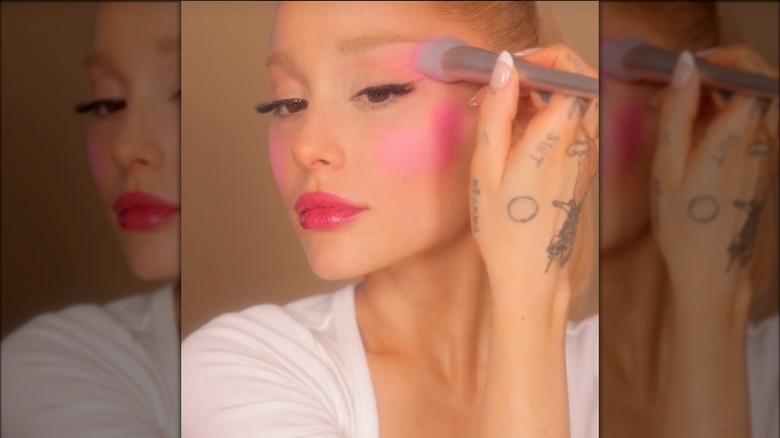 Ariana Grande applying powder blush