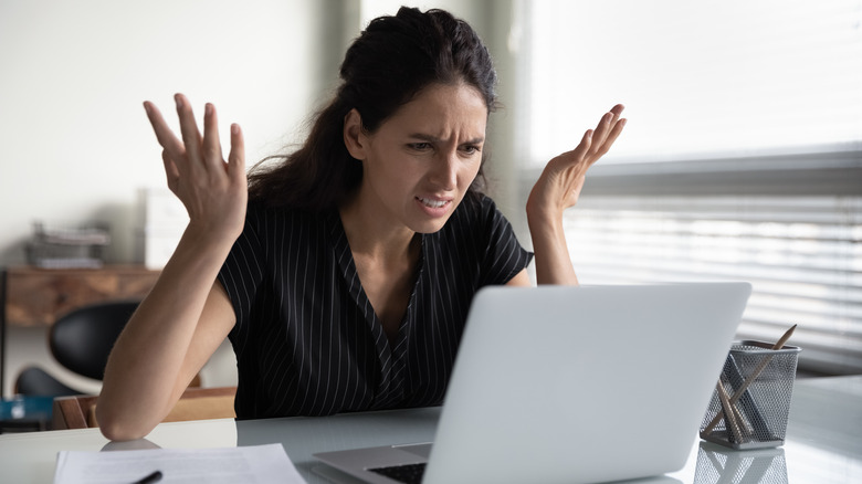 frustrated woman looking at laptop