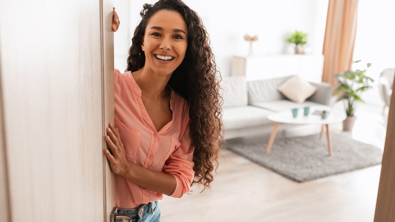 Woman welcoming people into her home