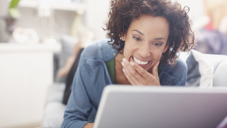 Woman smiling at laptop