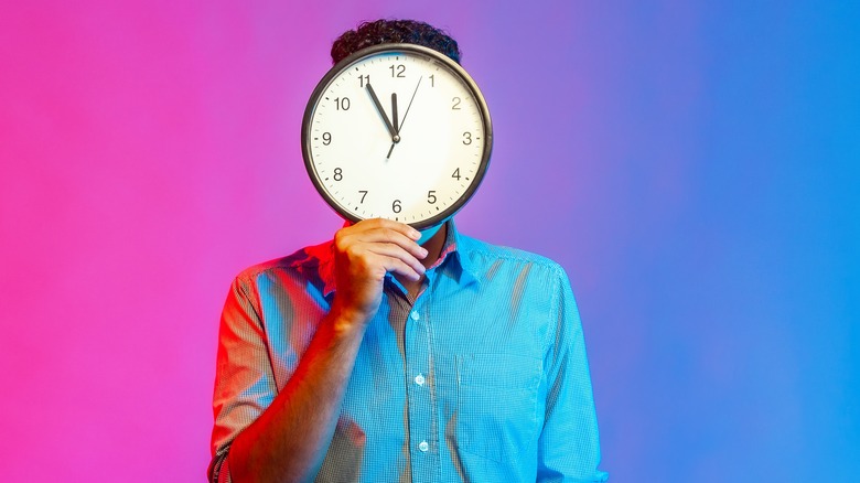 Person holding clock