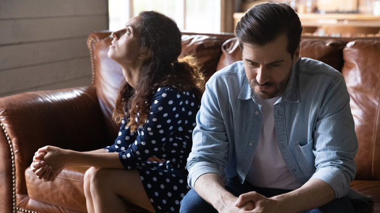 Couple sitting by each other 