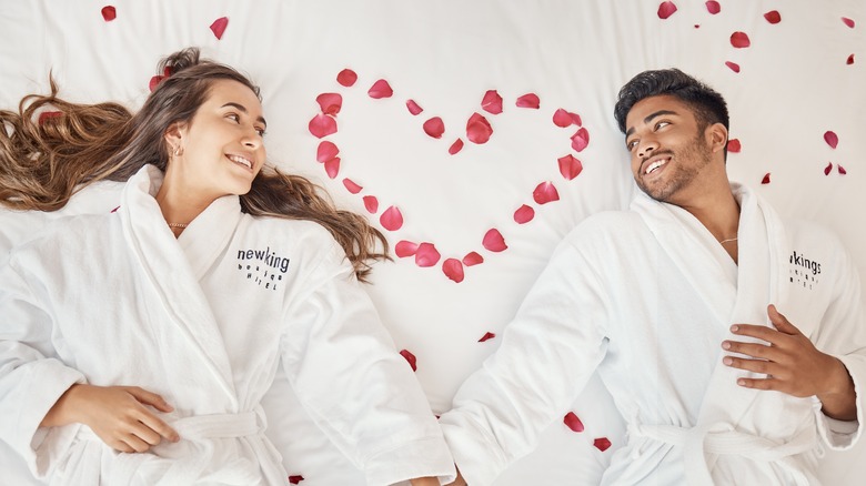 couple in robes holding hands 