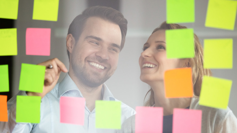 couple looking at sticky notes 