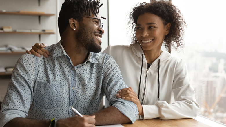 couple writing and smiling 