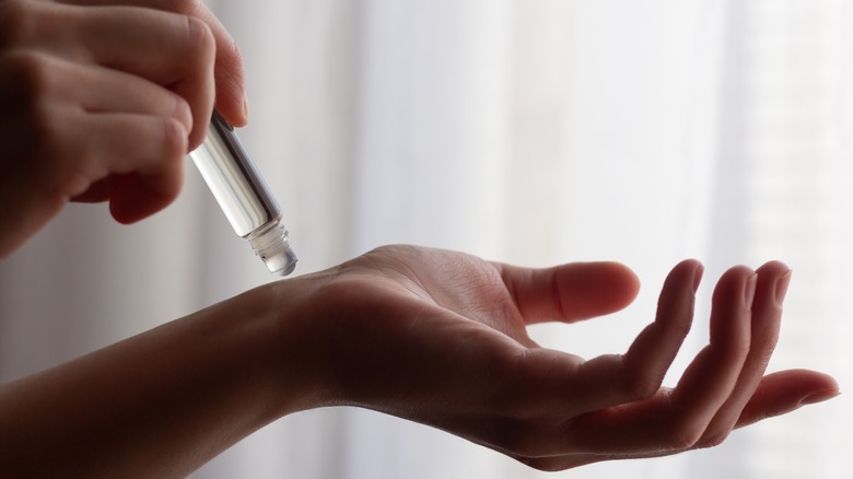 woman applying perfume