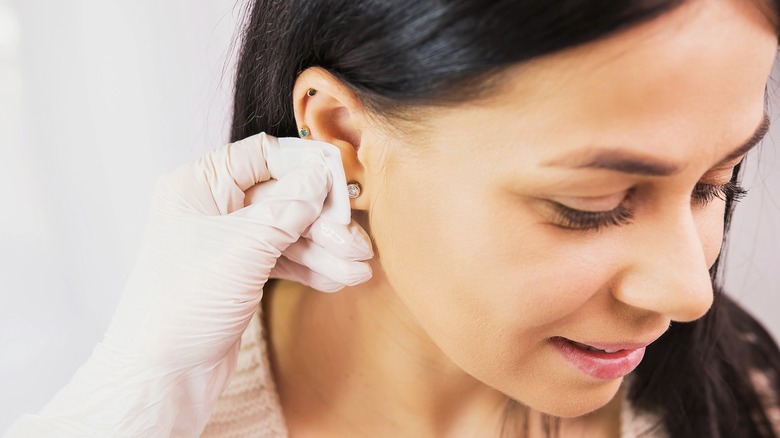 Person getting their ear pierced
