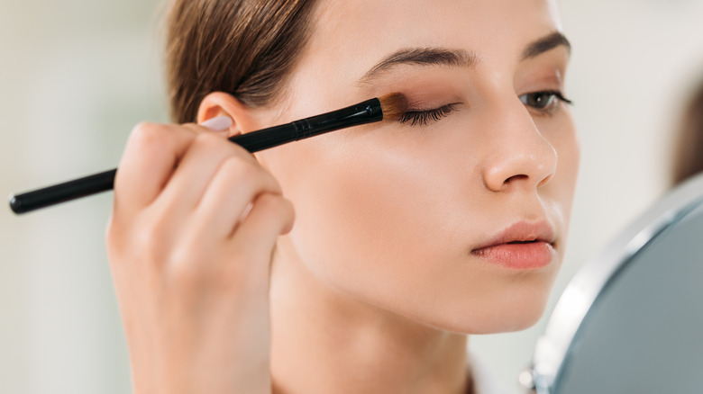 Woman applying eyeshadow