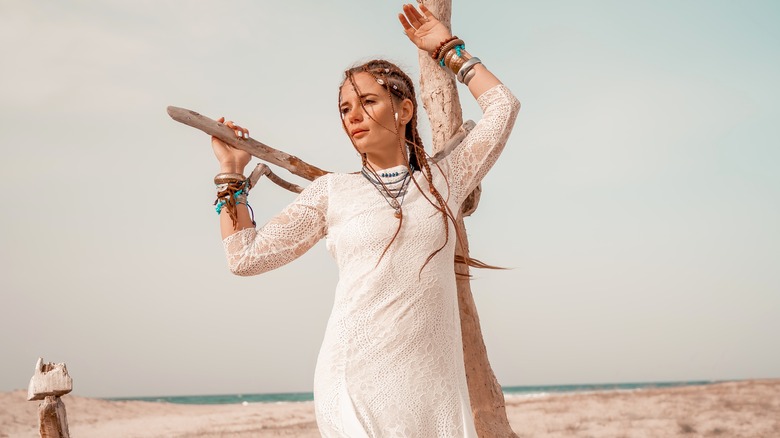 Woman wearing white with baby braids in hair