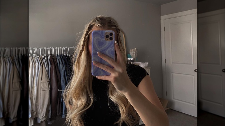 Woman's mirror selfie with loosening baby braids