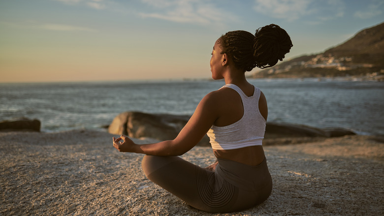 Woman meditating with eyes closed