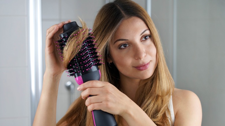 woman using heat styling tool